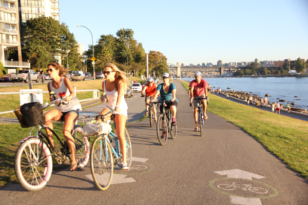 Canadians biking near the English Bay.