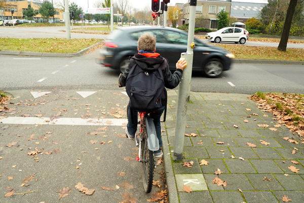 A boy biking home alone from school in Apeldoorn.