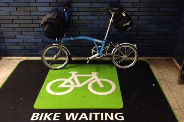 My Brompton with a full Brompton C Bag and a full Carradice Nelson long flap saddle bag at an Oakland BART station.